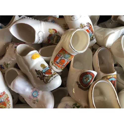 158 - Collectable ceramics, quantity of china  boots and shoes from various makers, to include some town a... 