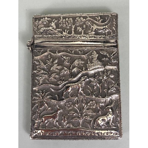 23 - Anglo-Indian silver card case with hinged lid and all over repousse decoration including tigers and ... 