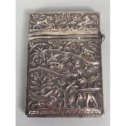 23 - Anglo-Indian silver card case with hinged lid and all over repousse decoration including tigers and ... 