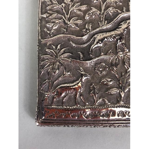 23 - Anglo-Indian silver card case with hinged lid and all over repousse decoration including tigers and ... 