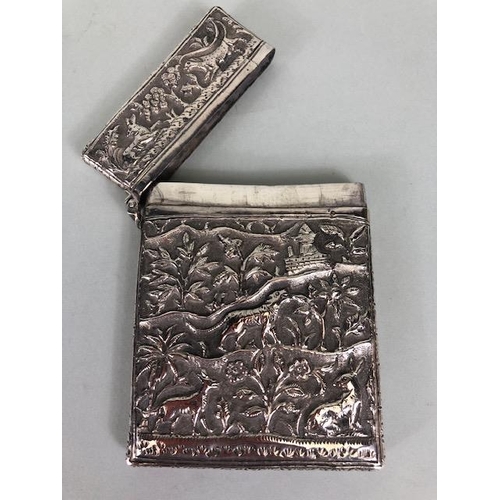 23 - Anglo-Indian silver card case with hinged lid and all over repousse decoration including tigers and ... 