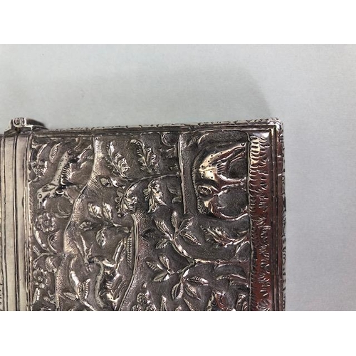 23 - Anglo-Indian silver card case with hinged lid and all over repousse decoration including tigers and ... 