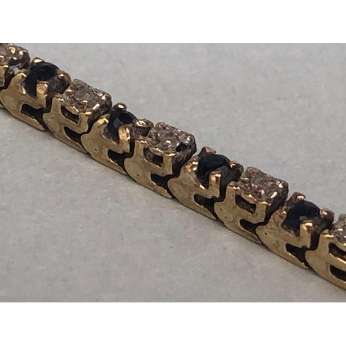 55 - 10k marked gold tennis bracelet set with alternate sapphires and diamonds approximately 64 stones, t... 