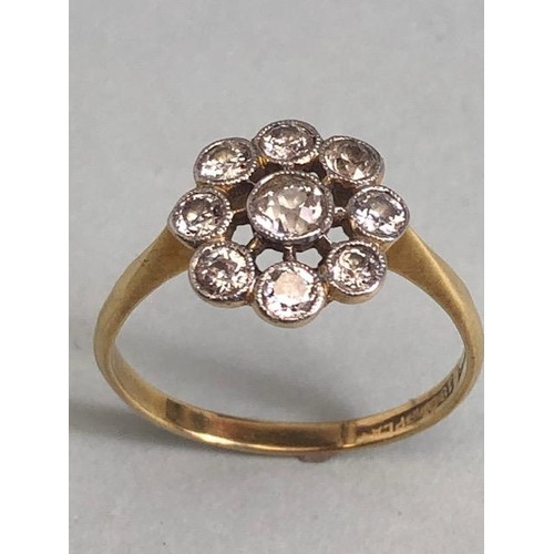 62 - 18ct yellow gold ring with 9 diamonds in a platinum setting of wheel design approximately size T and... 