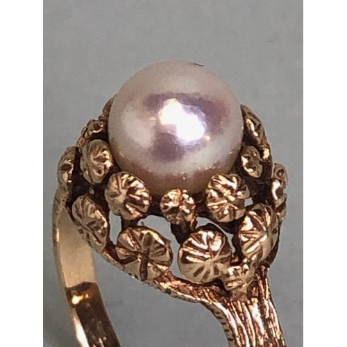 92 - 9ct Gold ring set with a single Pearl on a raised floral setting with bark effect to shoulders size ... 