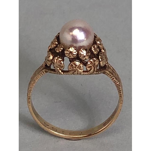 92 - 9ct Gold ring set with a single Pearl on a raised floral setting with bark effect to shoulders size ... 