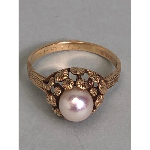 92 - 9ct Gold ring set with a single Pearl on a raised floral setting with bark effect to shoulders size ... 