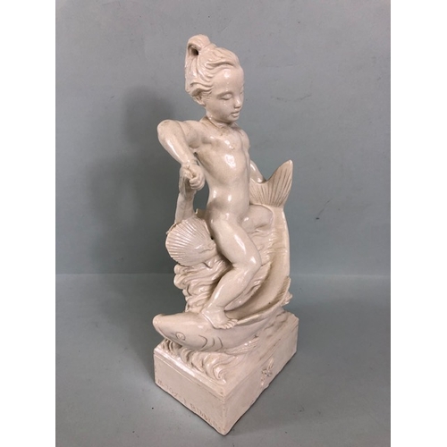 109B - Studio Ceramics, Blanc de Chine,  M Joyce Bidder figure depicting a child riding a fish as a represe... 