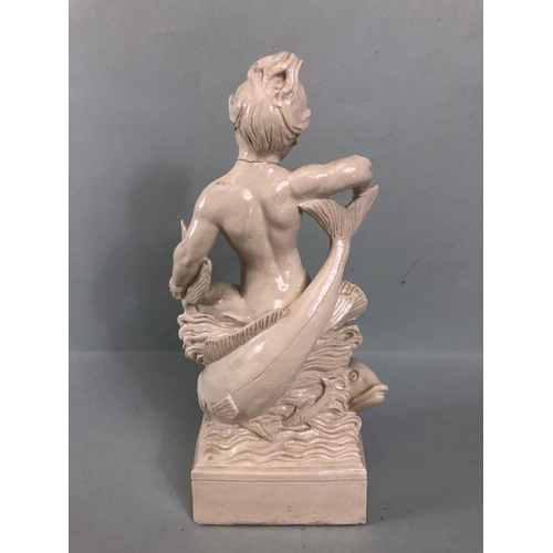 109B - Studio Ceramics, Blanc de Chine,  M Joyce Bidder figure depicting a child riding a fish as a represe... 