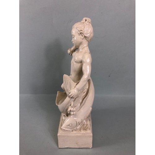 109B - Studio Ceramics, Blanc de Chine,  M Joyce Bidder figure depicting a child riding a fish as a represe... 