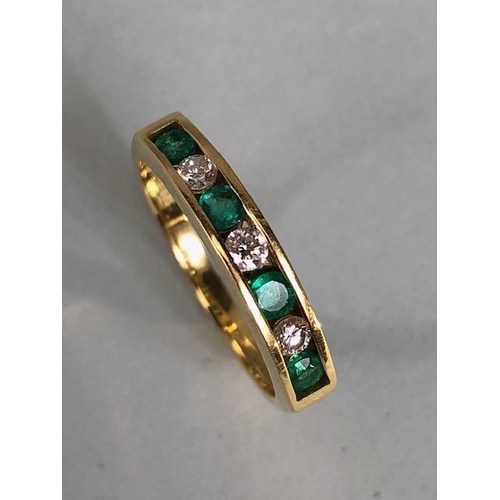 15 - 9ct quarter eternity ring set with four Emeralds and three diamonds, approximately 3.97g size P