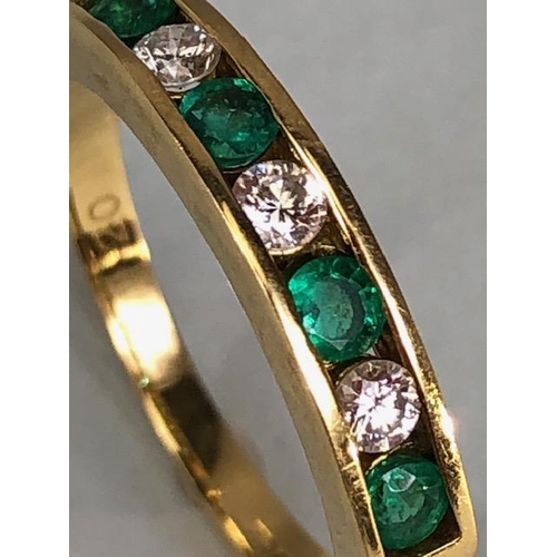 15 - 9ct quarter eternity ring set with four Emeralds and three diamonds, approximately 3.97g size P