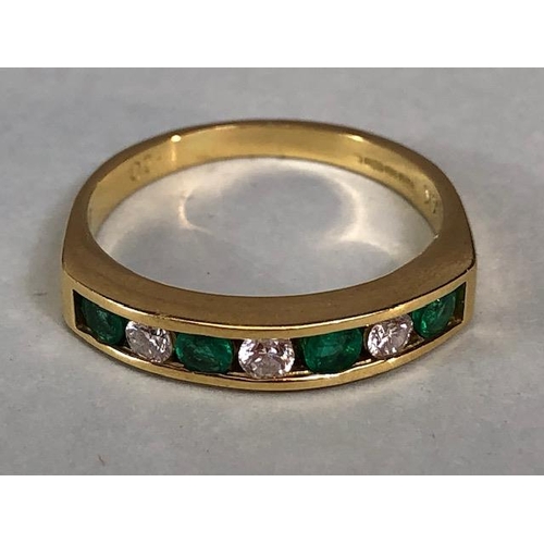 15 - 9ct quarter eternity ring set with four Emeralds and three diamonds, approximately 3.97g size P