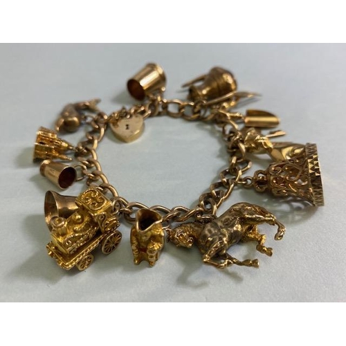 18 - 9ct Gold Charm bracelet with a good collection of 9ct Gold charms to include a Dolphin, Horse, teapo... 