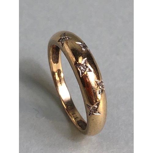 23 - 9ct Gold band/ ring set with five inset diamonds in a star settings approx size 'M' & 2g