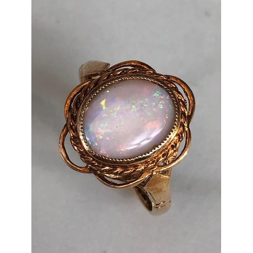 24 - 9ct gold hallmarked ring of petal design set with an oval Opal, approximately 2.7g, Size M