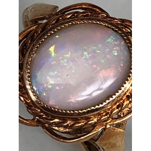 24 - 9ct gold hallmarked ring of petal design set with an oval Opal, approximately 2.7g, Size M