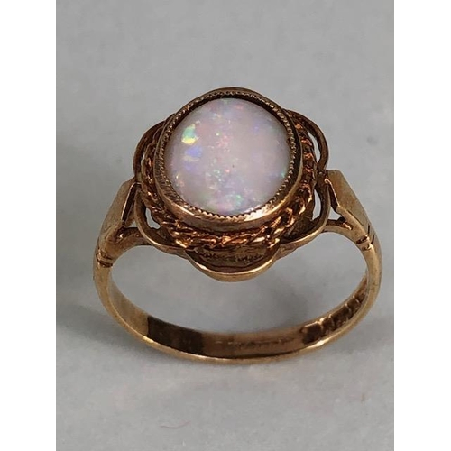 24 - 9ct gold hallmarked ring of petal design set with an oval Opal, approximately 2.7g, Size M