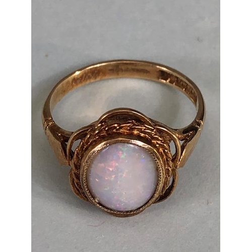 24 - 9ct gold hallmarked ring of petal design set with an oval Opal, approximately 2.7g, Size M