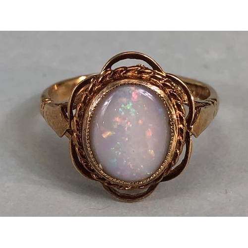 24 - 9ct gold hallmarked ring of petal design set with an oval Opal, approximately 2.7g, Size M