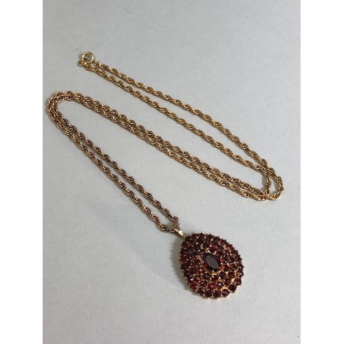 28 - 9ct Gold necklace with a pear shaped 9ct Gold pendant set with Garnet gemstones, necklace approx 60c... 