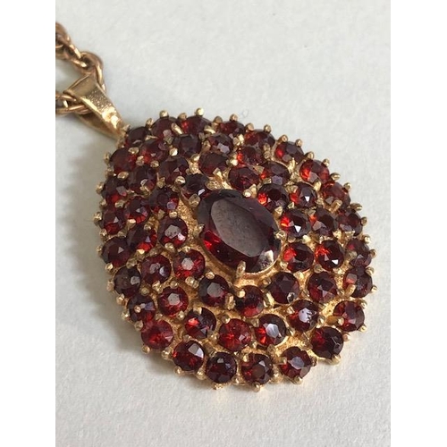 28 - 9ct Gold necklace with a pear shaped 9ct Gold pendant set with Garnet gemstones, necklace approx 60c... 