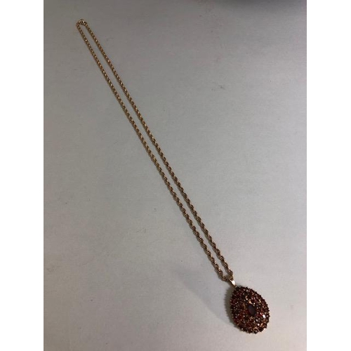 28 - 9ct Gold necklace with a pear shaped 9ct Gold pendant set with Garnet gemstones, necklace approx 60c... 