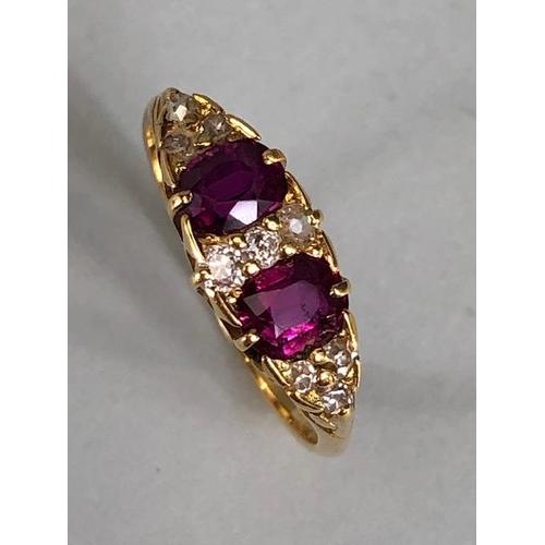 32 - Antique jewellery, 18ct marked ring set with two rubies and nine diamonds, approximately 3.03g, size... 