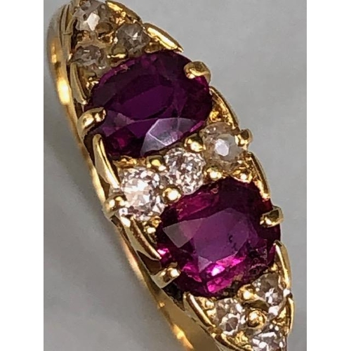 32 - Antique jewellery, 18ct marked ring set with two rubies and nine diamonds, approximately 3.03g, size... 