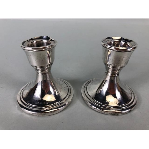 4 - Collection of hallmarked silver items to include a pair of squat candle sticks (weighted bases) a si... 