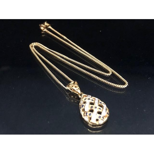 9 - 18ct Gold necklace with an 18ct Gold pear shaped pierced design pendant set with Diamonds and Sapphi... 