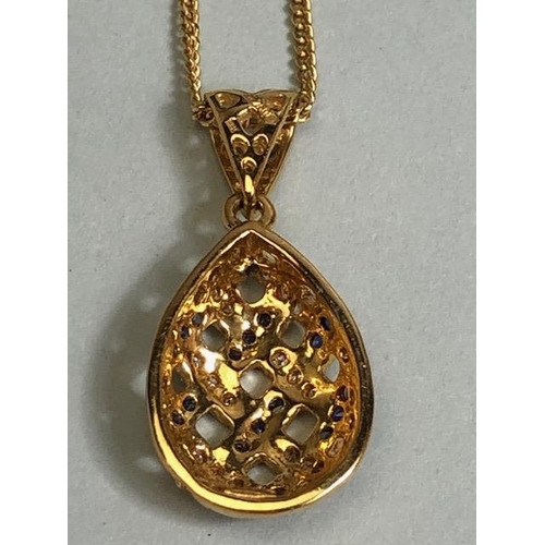 9 - 18ct Gold necklace with an 18ct Gold pear shaped pierced design pendant set with Diamonds and Sapphi... 