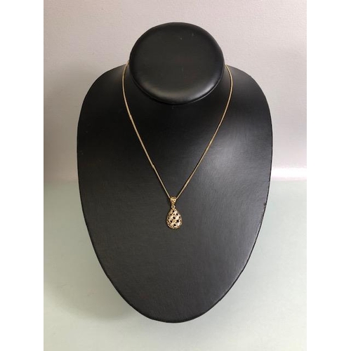 9 - 18ct Gold necklace with an 18ct Gold pear shaped pierced design pendant set with Diamonds and Sapphi... 