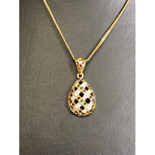 9 - 18ct Gold necklace with an 18ct Gold pear shaped pierced design pendant set with Diamonds and Sapphi... 