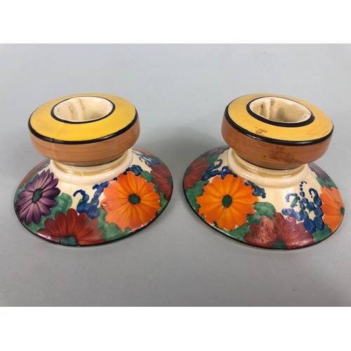 121 - Clarice Cliff, Art Deco interest, group of ceramics to include a pair of GAYDAY squat candle holders... 