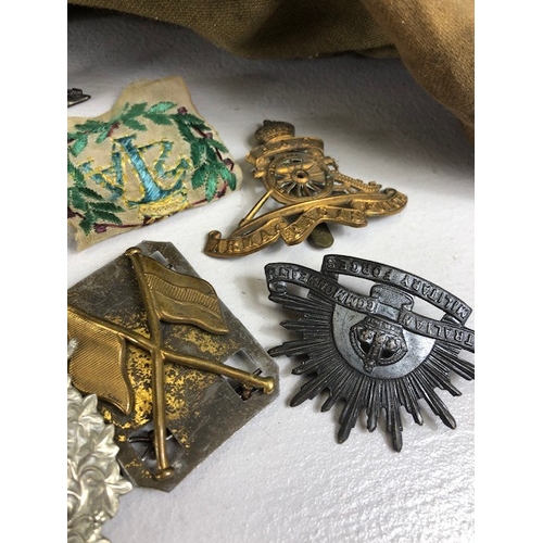 145 - Military interest collection of WW1 and WW2 items to include British and commonwealth cap badges col... 