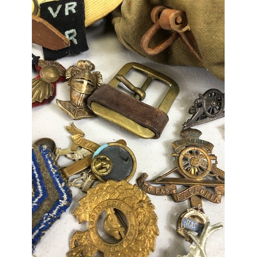 145 - Military interest collection of WW1 and WW2 items to include British and commonwealth cap badges col... 