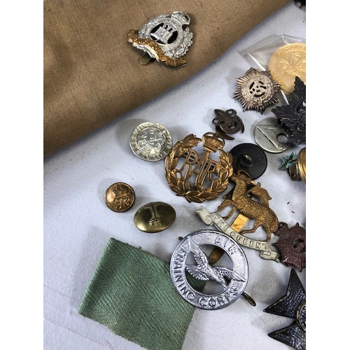 145 - Military interest collection of WW1 and WW2 items to include British and commonwealth cap badges col... 