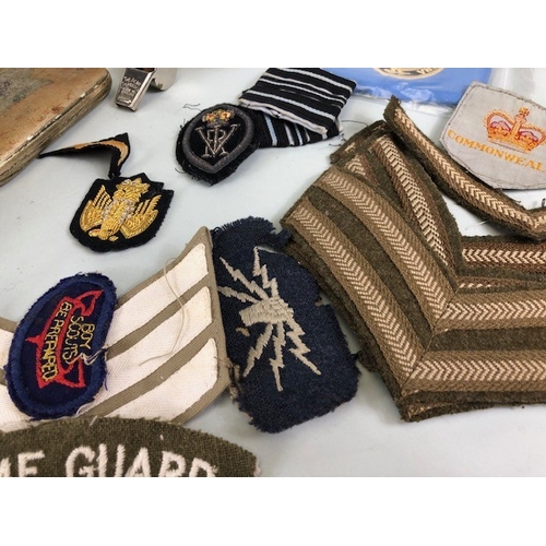 145 - Military interest collection of WW1 and WW2 items to include British and commonwealth cap badges col... 