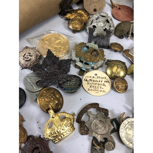 145 - Military interest collection of WW1 and WW2 items to include British and commonwealth cap badges col... 