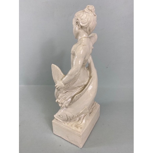 169 - Studio Ceramics, Blanc de Chine,  M Joyce Bidder figure depicting a child riding a fish as a represe... 