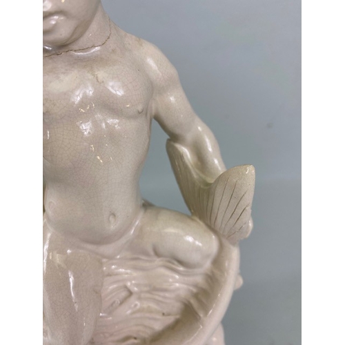 169 - Studio Ceramics, Blanc de Chine,  M Joyce Bidder figure depicting a child riding a fish as a represe... 