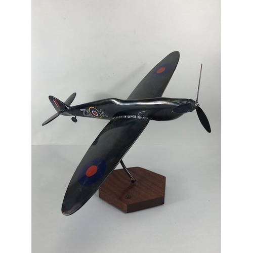 178 - Military interest, metal model of a flying Spitfire mounted on wooden base, approximately 45 x 48 x ... 