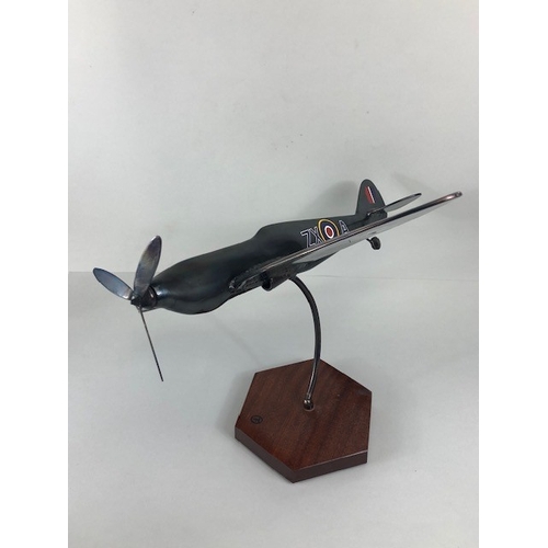 178 - Military interest, metal model of a flying Spitfire mounted on wooden base, approximately 45 x 48 x ... 