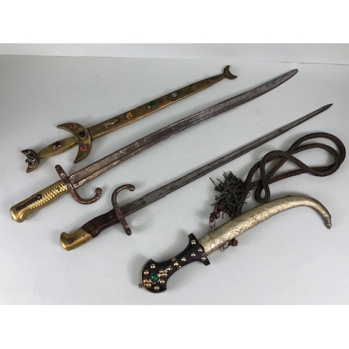 181 - Military interest, two French WW1 bayonets, white metal mounted Moroccan Jambiya, 19th century brass... 