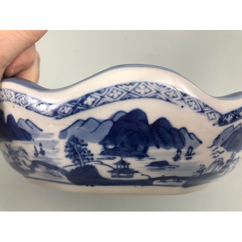 185 - Oriental ceramics, blue and white dish with fluted rim depicting a village landscape, unglazed base ... 