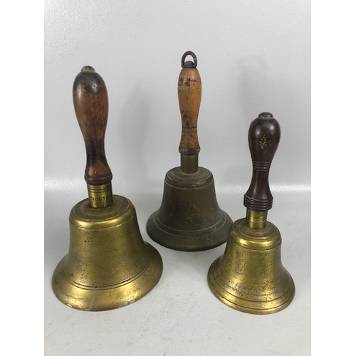 192 - Antique bells, three large hand bells of school type, with turned wooden handles, one marked 