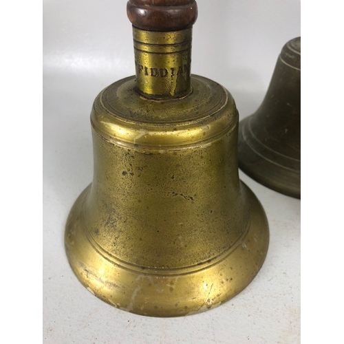 192 - Antique bells, three large hand bells of school type, with turned wooden handles, one marked 