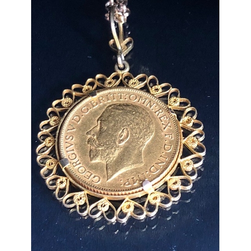 20 - Gold Sovereign dated 1911, in a fancy 9ct pendant mount of hearts, suspended from a 9ct gold belcher... 