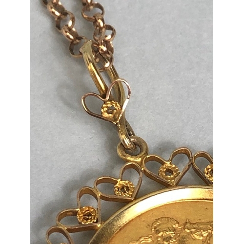 20 - Gold Sovereign dated 1911, in a fancy 9ct pendant mount of hearts, suspended from a 9ct gold belcher... 